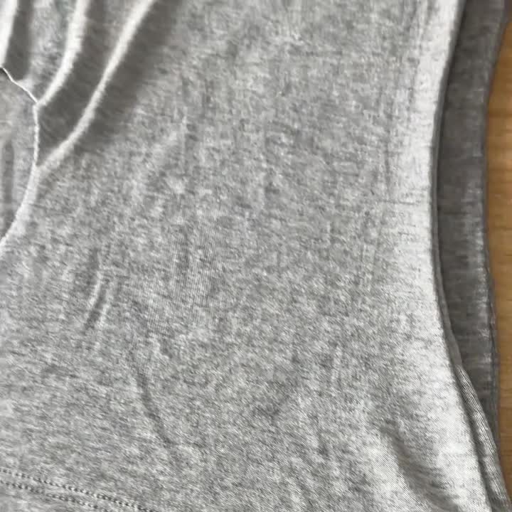 Close-up of a grey garment hem and stitching in HF Garments workshop footage